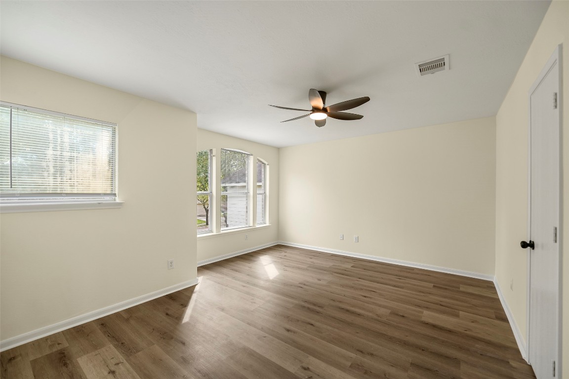 13226 Ridgewood Knoll Lane Houston, TX 77047 - Photo 19 of 37 a view of an empty room with wooden floor and a window