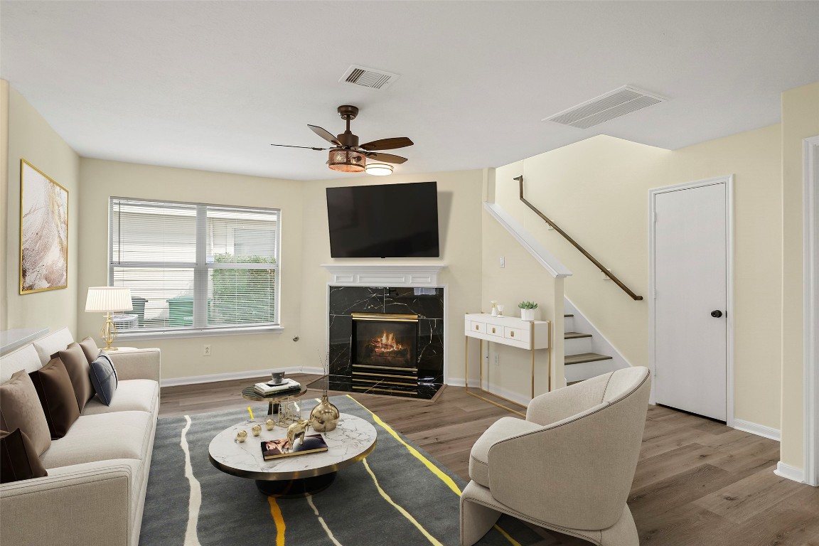 13226 Ridgewood Knoll Lane Houston, TX 77047 - Photo 2 of 37 a living room with furniture a fireplace and a flat screen tv