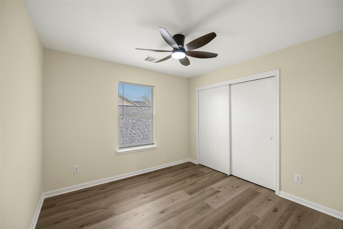 13226 Ridgewood Knoll Lane Houston, TX 77047 - Photo 22 of 37 a view of an empty room with wooden floor and a window