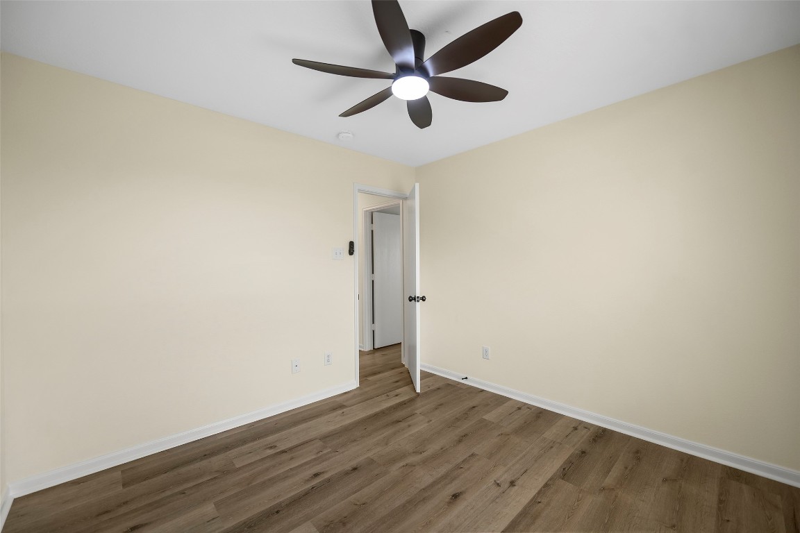 13226 Ridgewood Knoll Lane Houston, TX 77047 - Photo 23 of 37 an empty room with wooden floor and ceiling fan