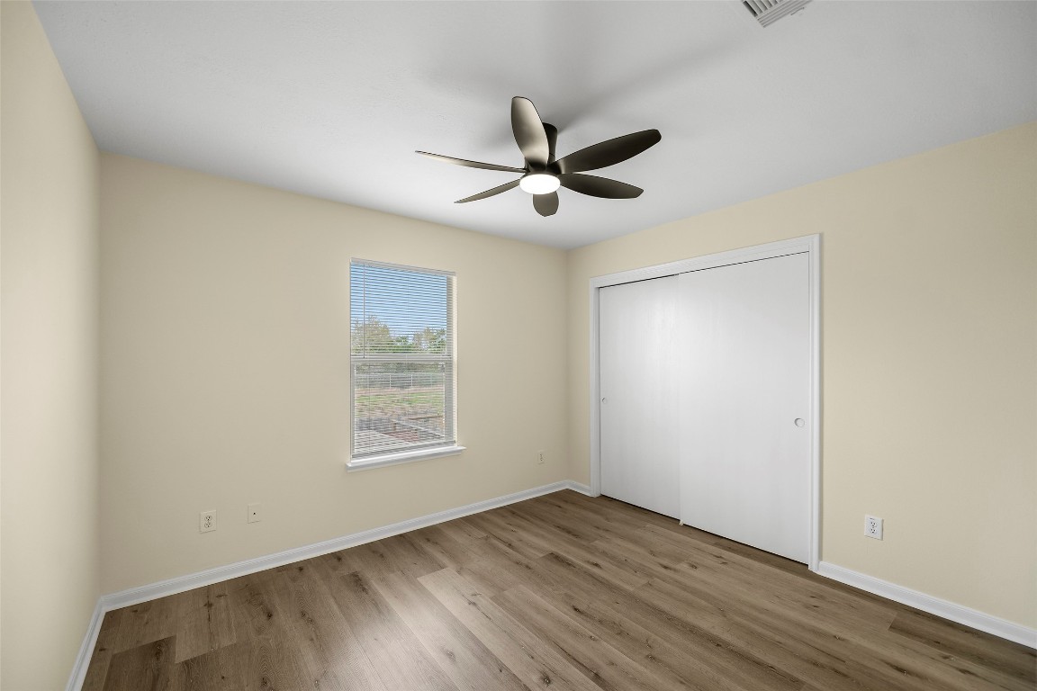 13226 Ridgewood Knoll Lane Houston, TX 77047 - Photo 24 of 37 a view of empty room with wooden floor and fan