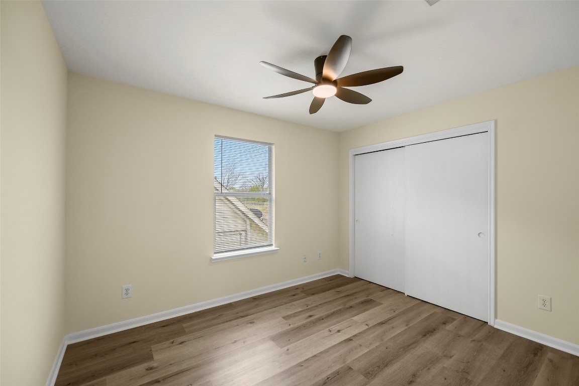13226 Ridgewood Knoll Lane Houston, TX 77047 - Photo 27 of 37 a view of empty room with wooden floor and fan