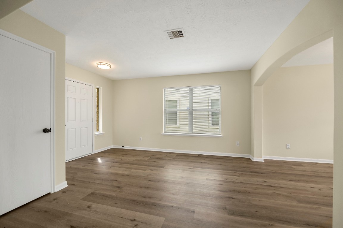 13226 Ridgewood Knoll Lane Houston, TX 77047 - Photo 29 of 37 a view of an empty room with wooden floor and a window
