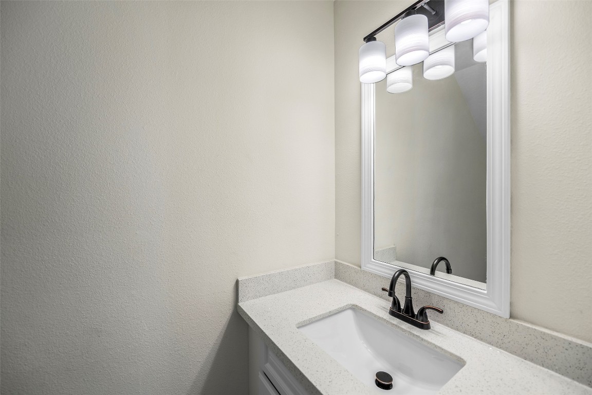 13226 Ridgewood Knoll Lane Houston, TX 77047 - Photo 30 of 37 a bathroom with a sink and a mirror