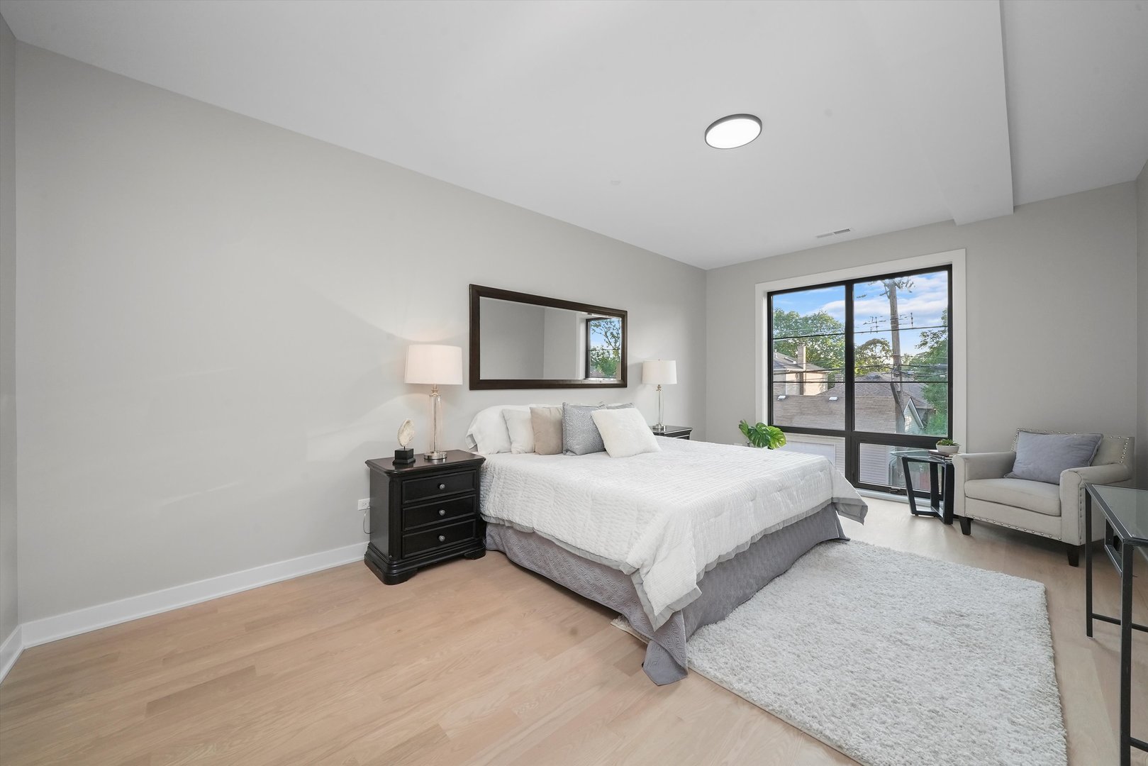 6246 North Pulaski Road, Unit 204 Chicago, IL 60646 - Photo 22 of 38 a bedroom with a bed and a couch