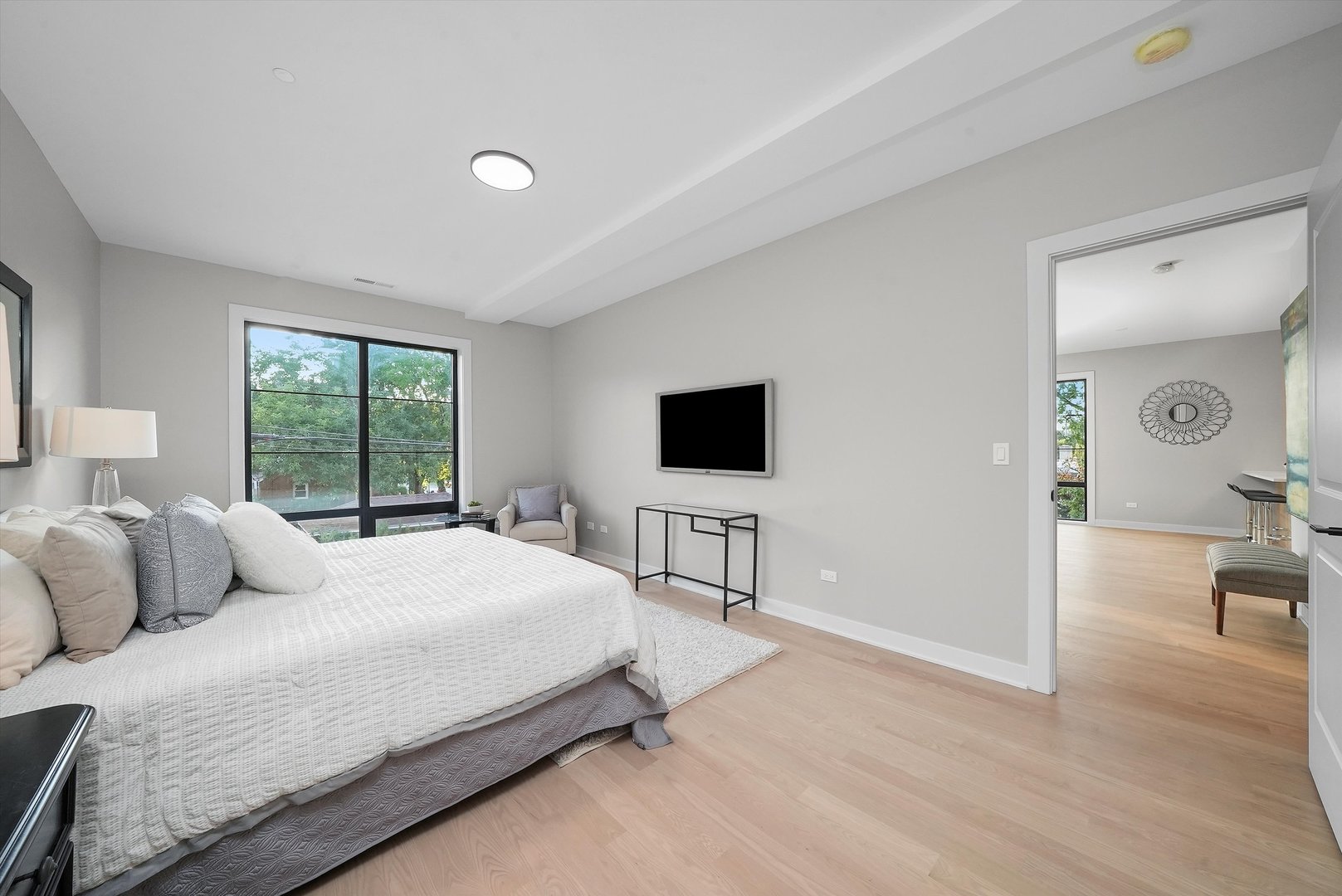 6246 North Pulaski Road, Unit 204 Chicago, IL 60646 - Photo 23 of 38 a bedroom with a bed and a flat screen tv