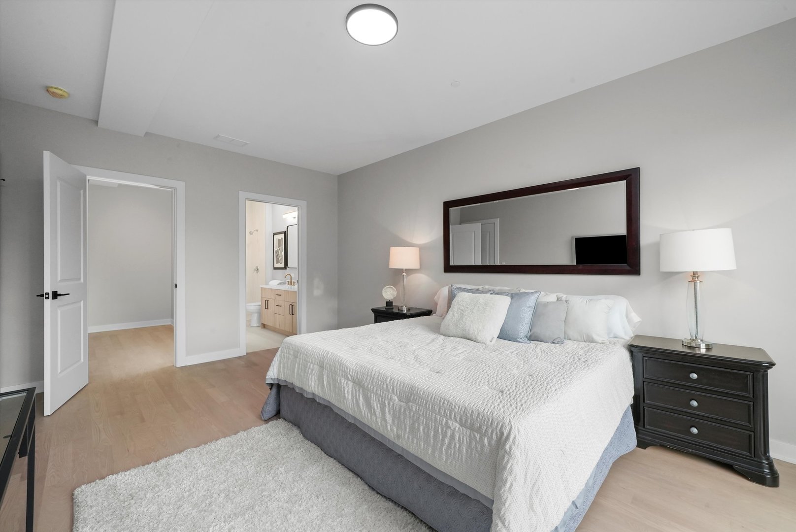 6246 North Pulaski Road, Unit 204 Chicago, IL 60646 - Photo 24 of 38 a bedroom with a bed and a night stand