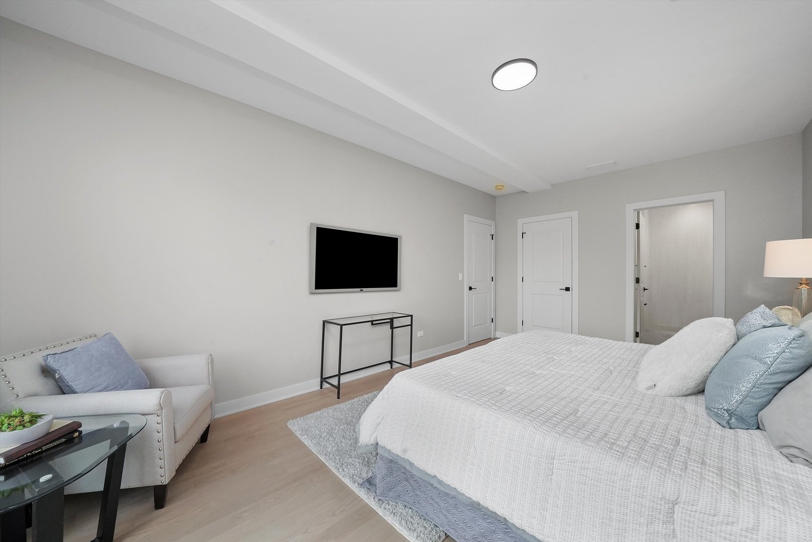 6246 North Pulaski Road, Unit 204 Chicago, IL 60646 - Photo 25 of 38 a bedroom with a bed and a flat screen tv