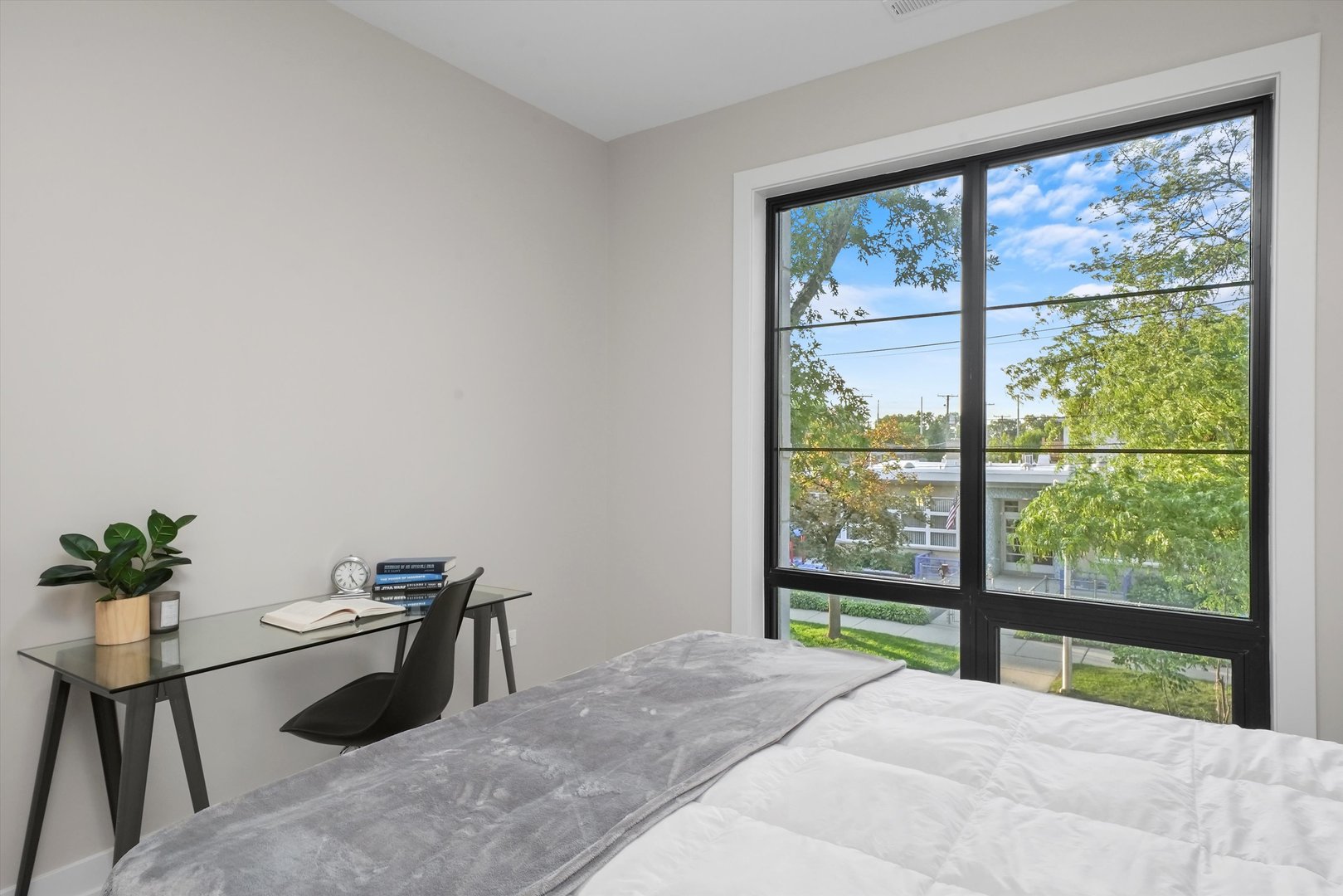 6246 North Pulaski Road, Unit 204 Chicago, IL 60646 - Photo 26 of 38 a bedroom with a bed and a large window