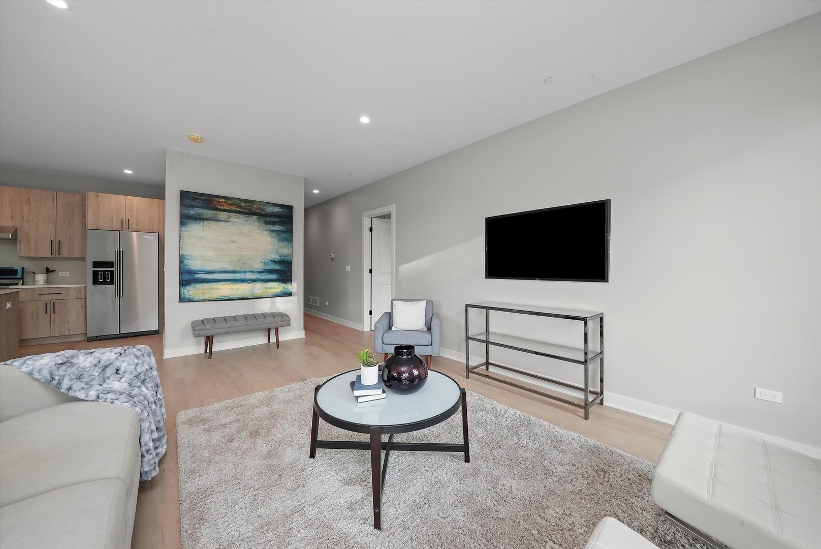 6246 North Pulaski Road, Unit 204 Chicago, IL 60646 - Photo 8 of 38 a living room with furniture and a flat screen tv