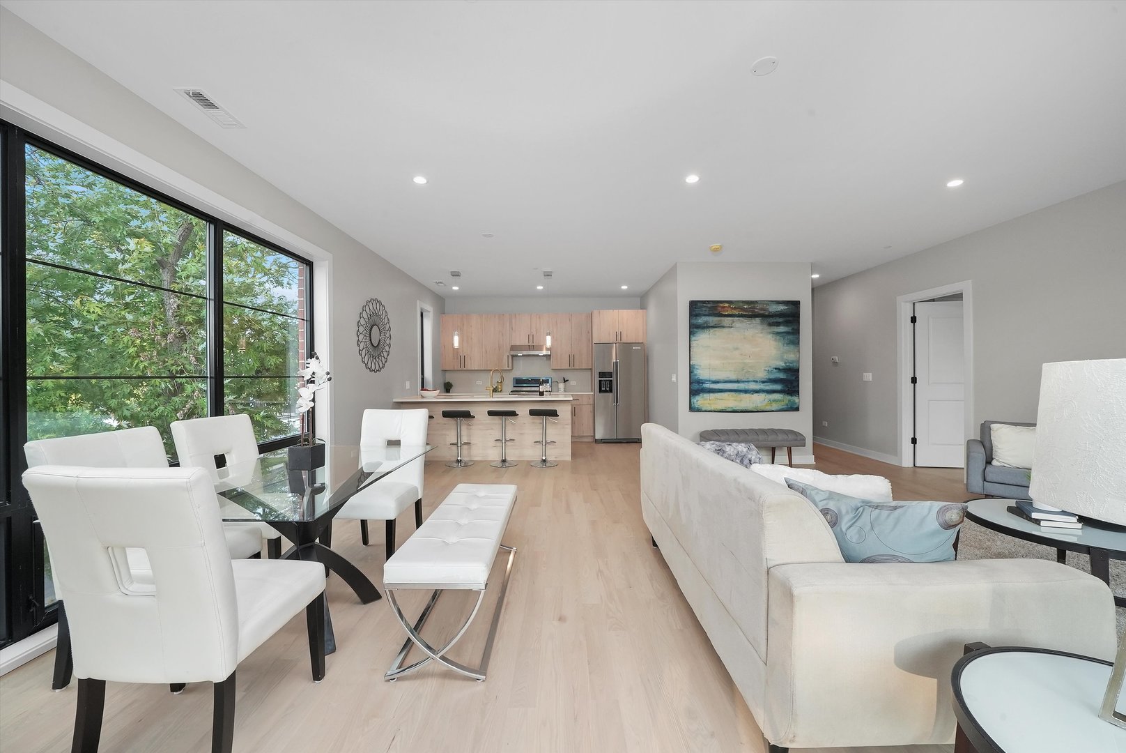 6246 North Pulaski Road, Unit 204 Chicago, IL 60646 - Photo 9 of 38 a living room with furniture wooden floor and a large window