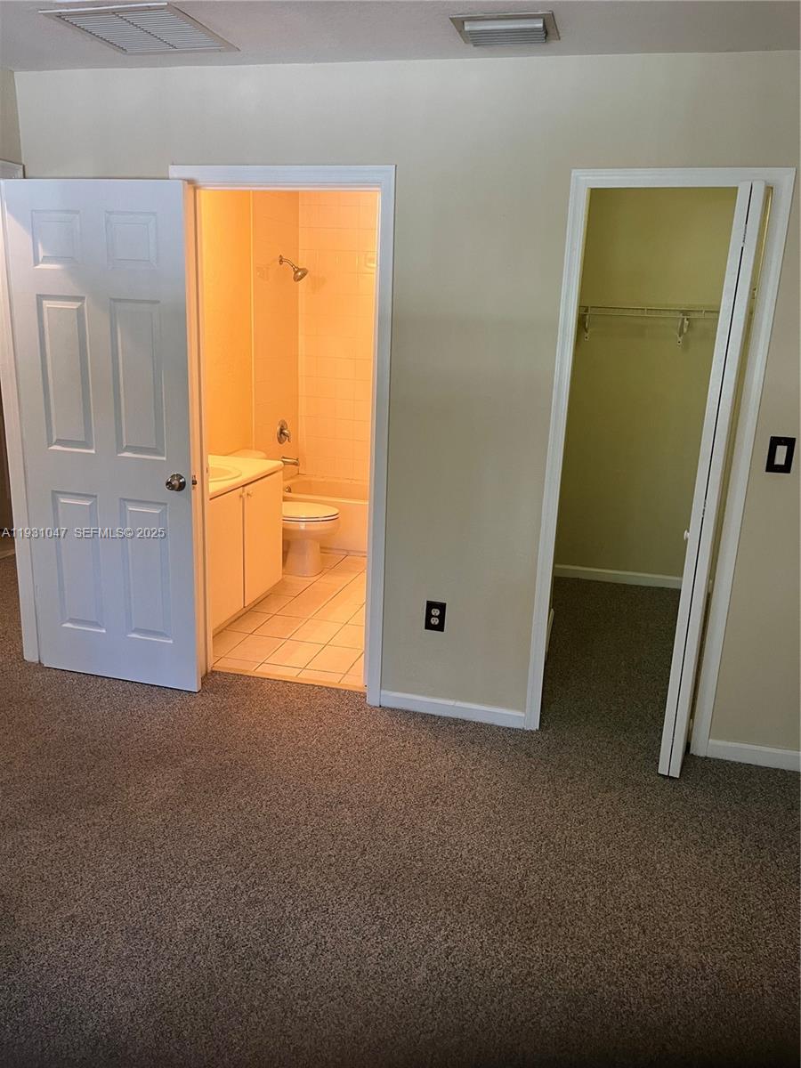 2508 Southeast 14th Avenue, Unit 287 Homestead, FL 33035 - Photo 7 of 17 an empty room with windows and closet