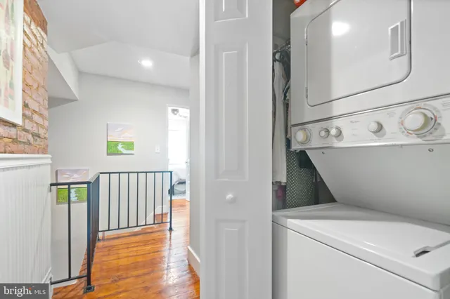 a view of washer and dryer with wooden floor