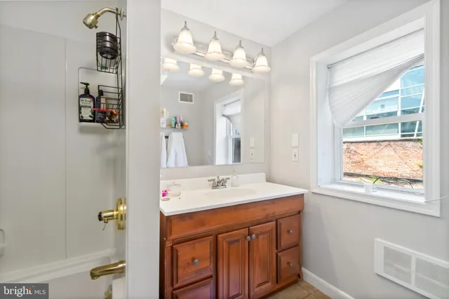 a bathroom with a sink a vanity and a mirror