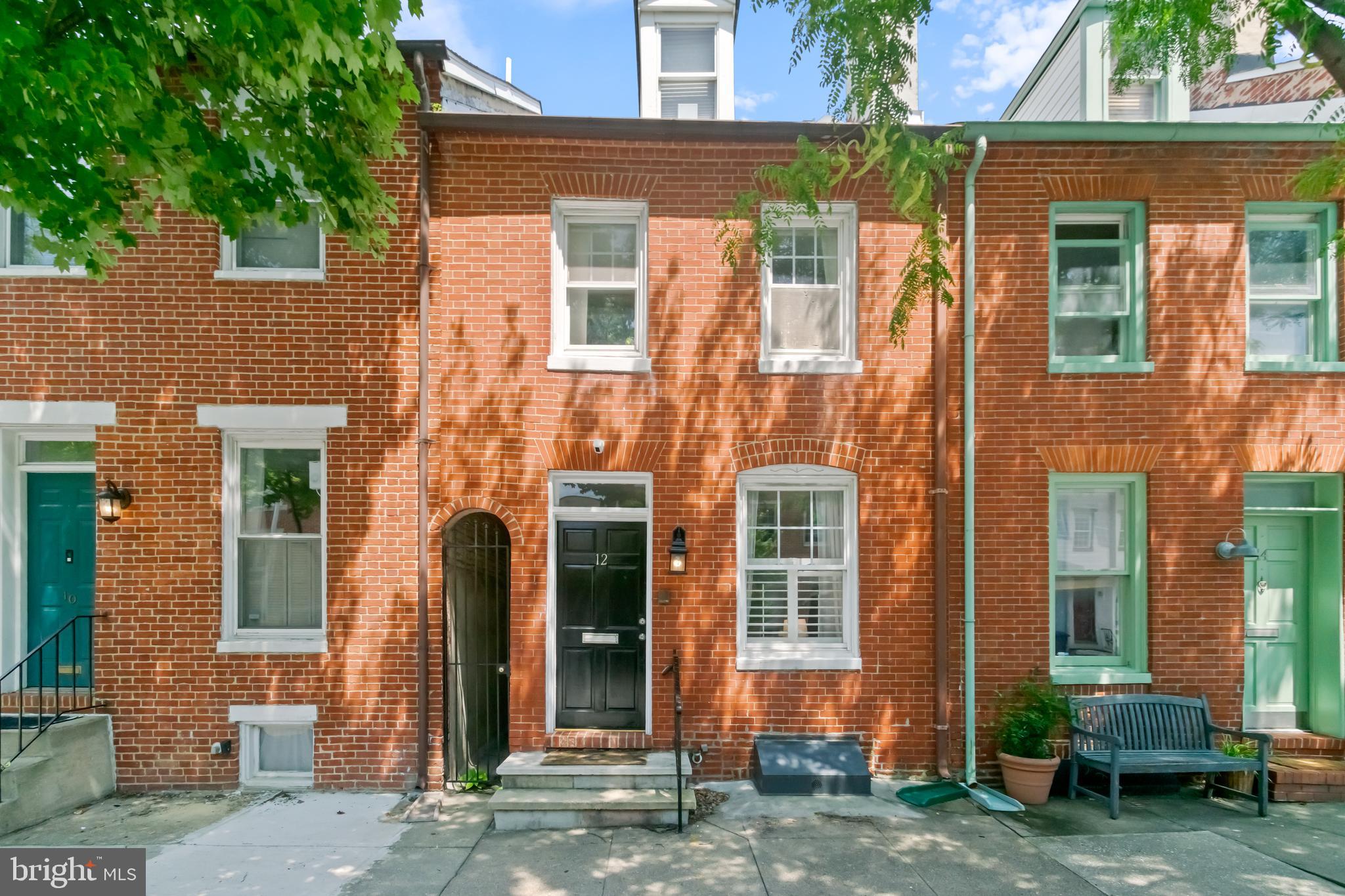 12 East Henrietta Street Baltimore, MD 21230 - Photo 2 of 24 front view of a brick house with a yard