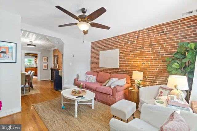 a living room with furniture a window and a dining table