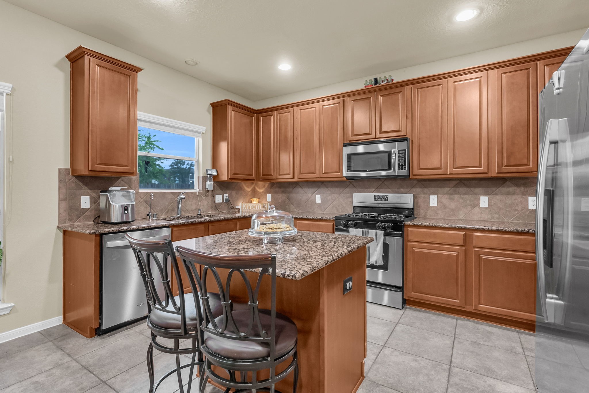 16619 Dover Mills Drive Spring, TX 77379 - Photo 16 of 49 a kitchen with stainless steel appliances granite countertop a stove top oven a sink a dining table and chairs