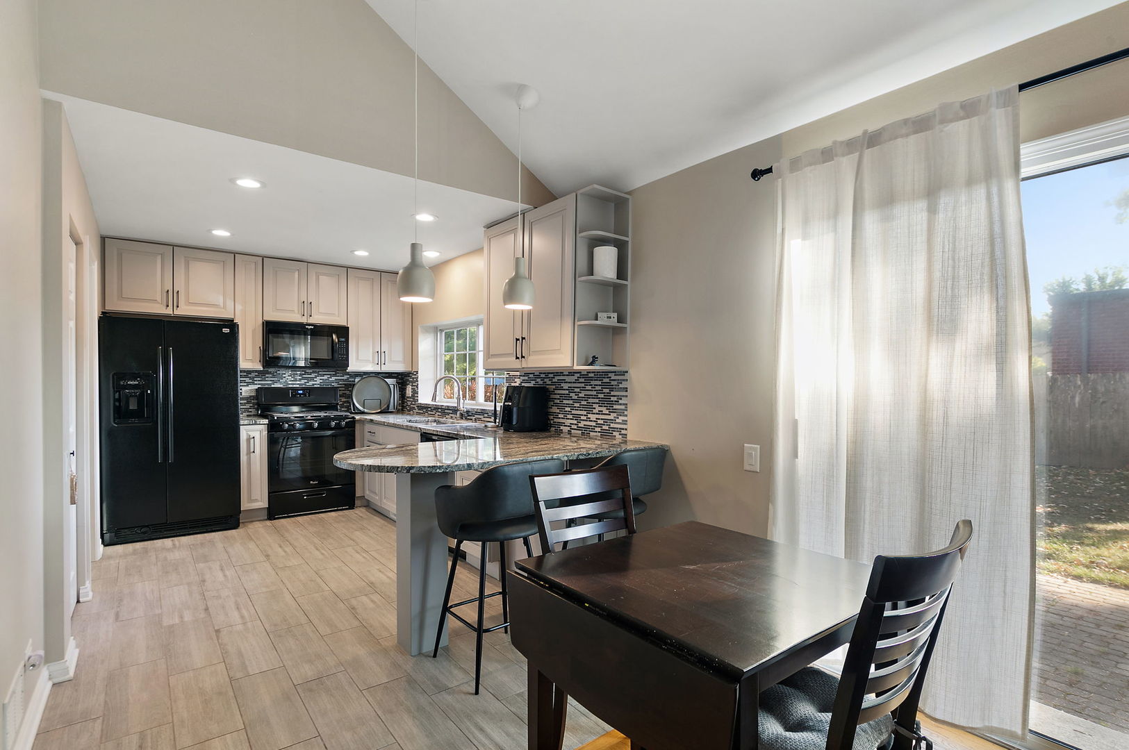 1925 Ozark Parkway Algonquin, IL 60102 - Photo 5 of 17 a kitchen with stainless steel appliances granite countertop a refrigerator a stove a sink a dining table and chairs
