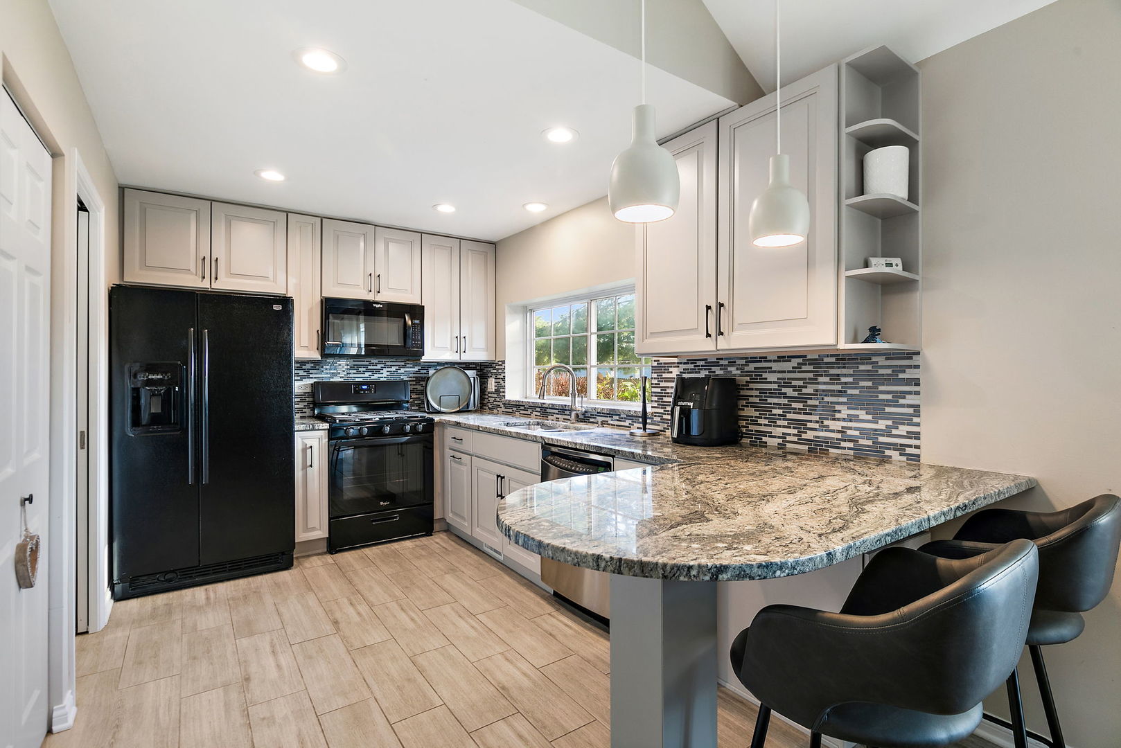 1925 Ozark Parkway Algonquin, IL 60102 - Photo 6 of 17 a kitchen with kitchen island granite countertop a sink stove and refrigerator