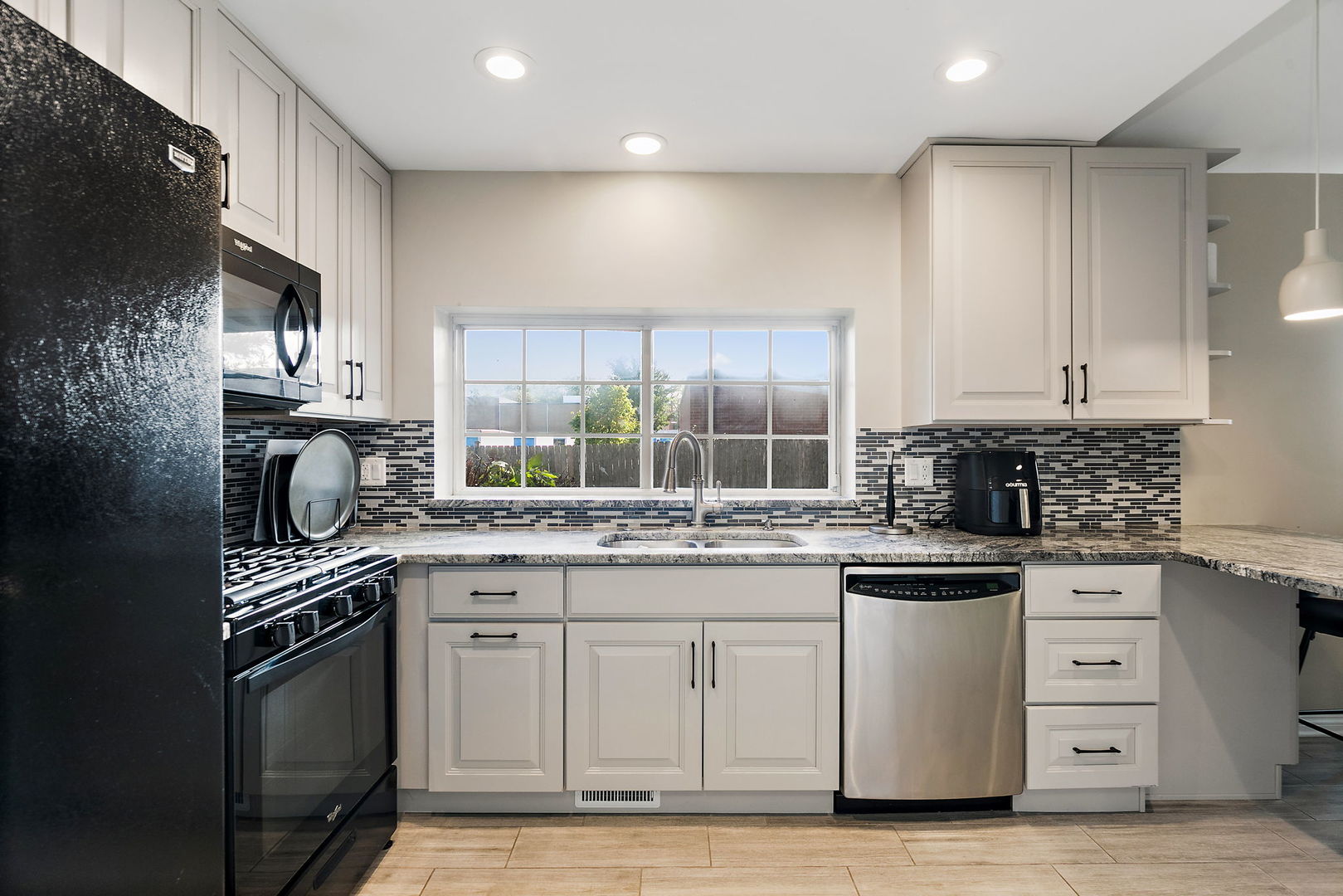 1925 Ozark Parkway Algonquin, IL 60102 - Photo 7 of 17 a kitchen with white cabinets stainless steel appliances and sink