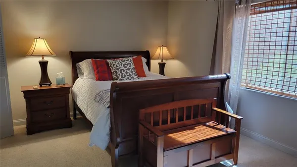 a bedroom with a bed and a lamp on table