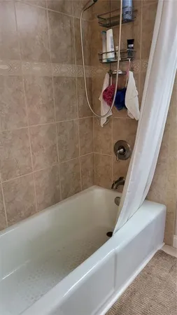 a bathroom with a bathtub and shower