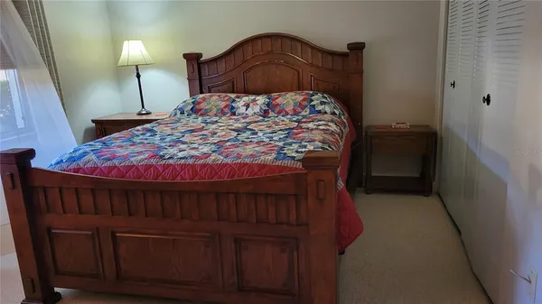 a bedroom with a bed and a lamp