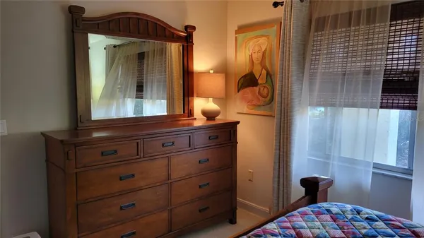 a view of hallway with mirror and furniture
