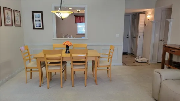 a view of a dining room with furniture and a chandelier