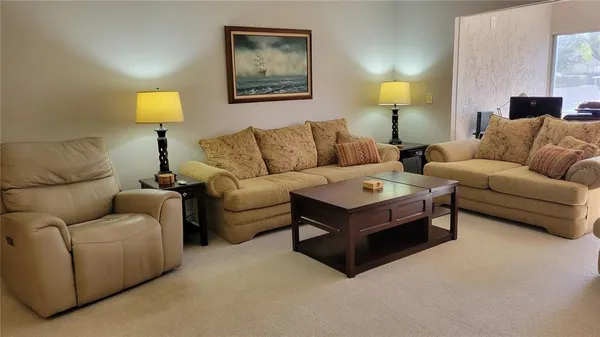 a living room with furniture and a lamp
