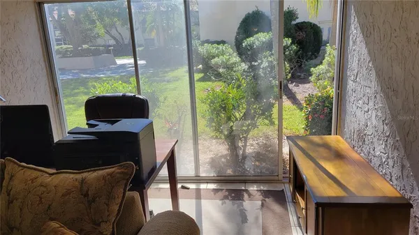 a living room filled with furniture and a floor to ceiling window