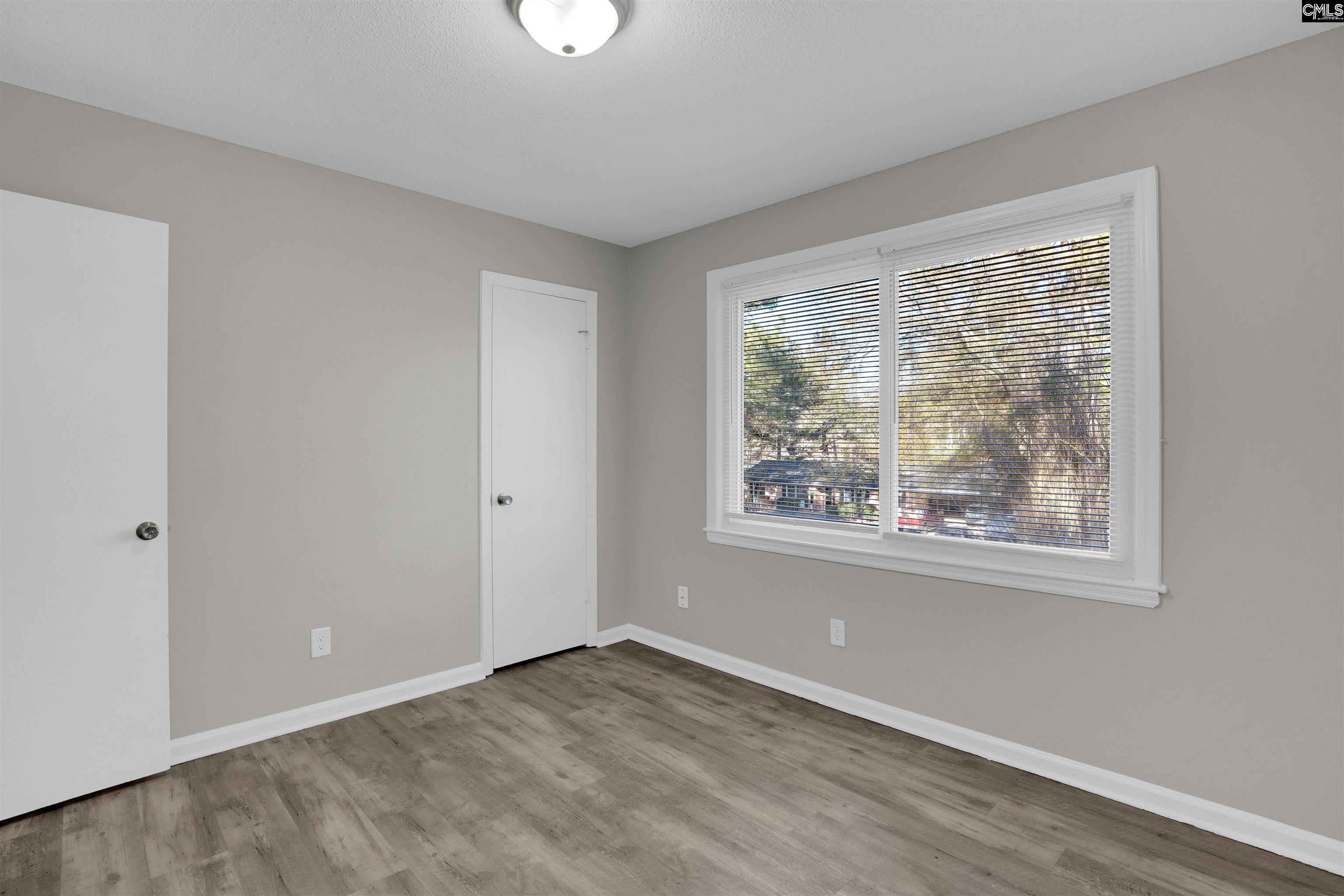2620 Pleasant Ridge Drive Columbia, SC 29209 - Photo 34 of 37 a view of an empty room with wooden floor and a window