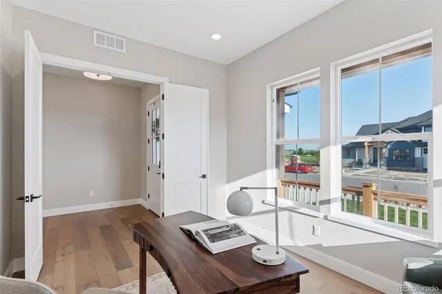 a living room with furniture and a book shelf