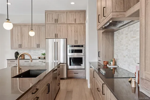 a kitchen with a refrigerator and a sink