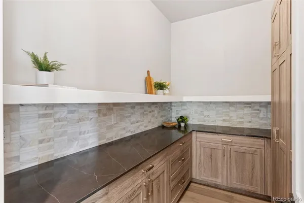 a kitchen with stainless steel appliances kitchen island a chandelier and refrigerator