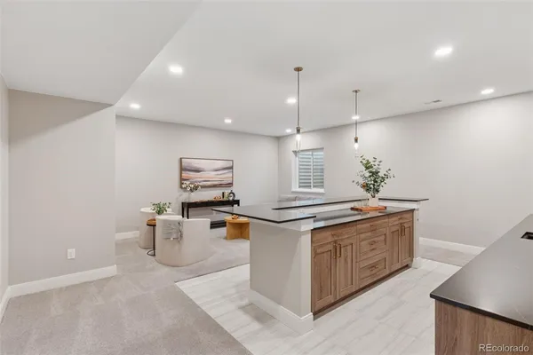 a kitchen with stainless steel appliances a sink a potted plant and a counter top space