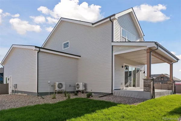 a front view of a house with a yard and seating space