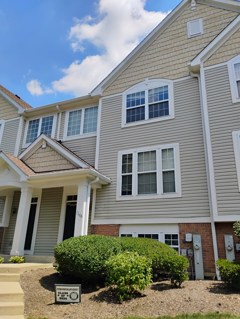 1166 Georgetown Way Vernon Hills, IL 60061 - Photo 2 of 36 a front view of a house with a yard