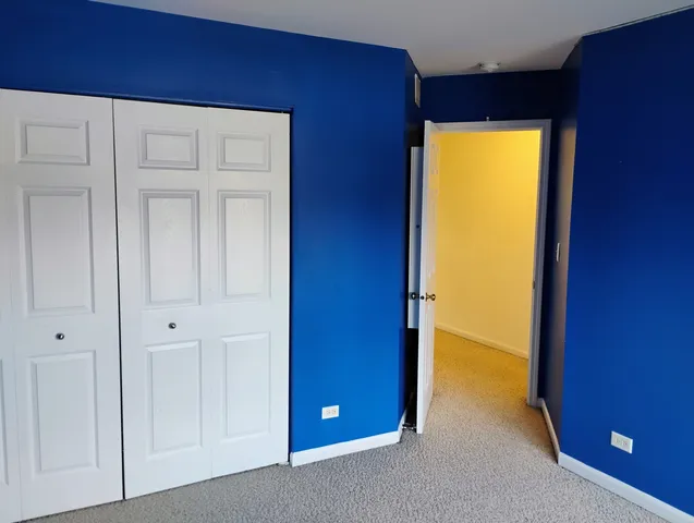 a view of an empty room with closet area