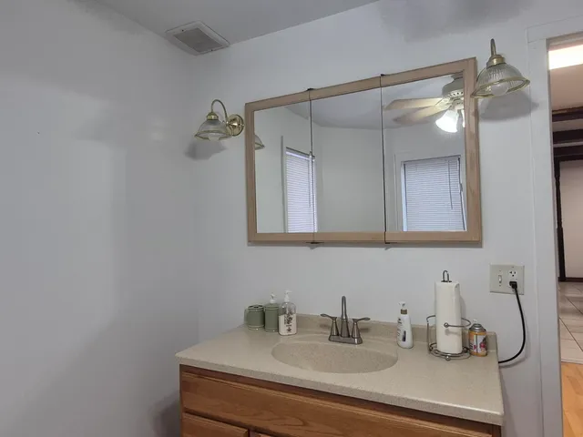 a kitchen with granite countertop a sink and cabinets