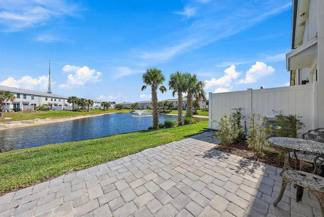a view of a house with a yard and potted plants