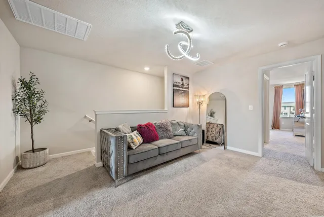 a living room with furniture and a chandelier