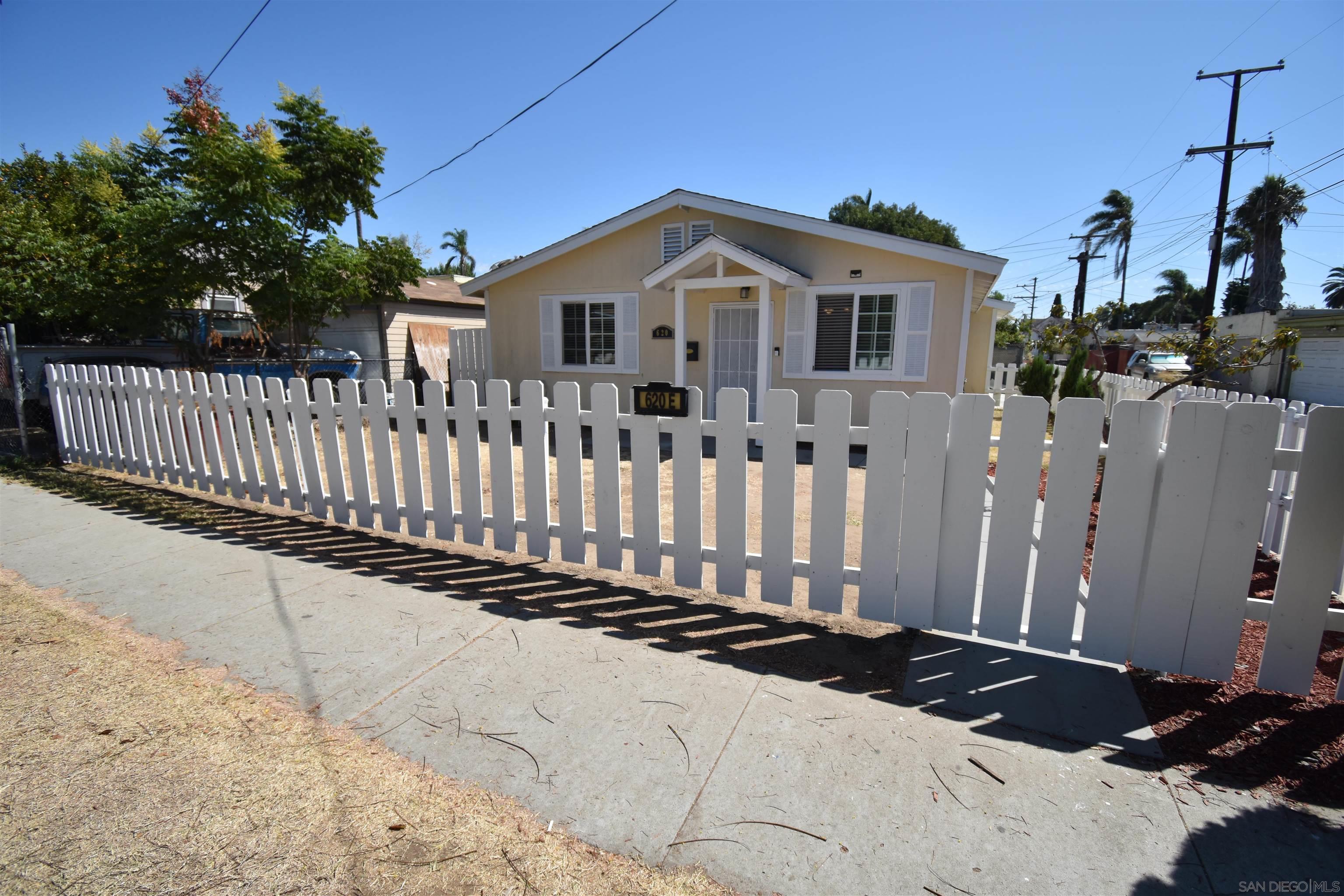 620 East 4th Street National City, CA 91950 - Photo 1 of 22 a white house that has tree in front of it