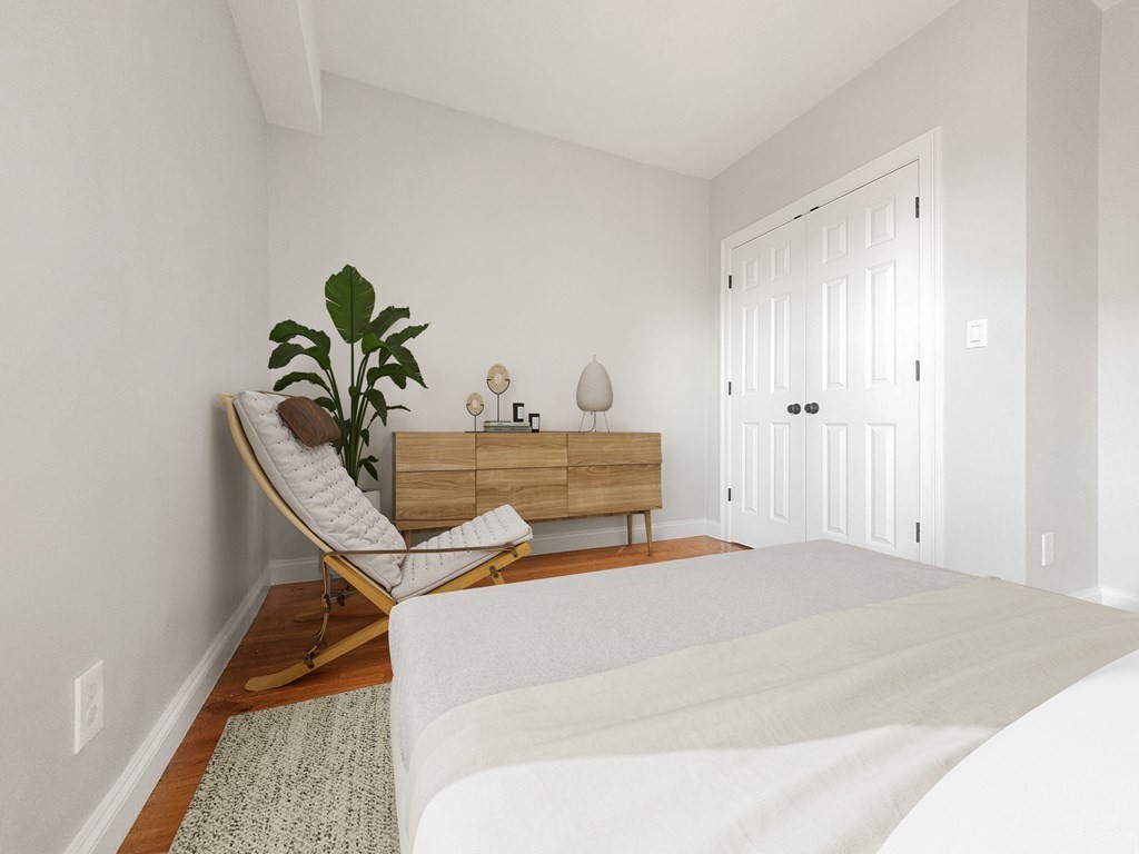 26 Arcadia Street, Unit 3R Boston, MA 02122 - Photo 2 of 8 a bedroom with a bed and a potted plant