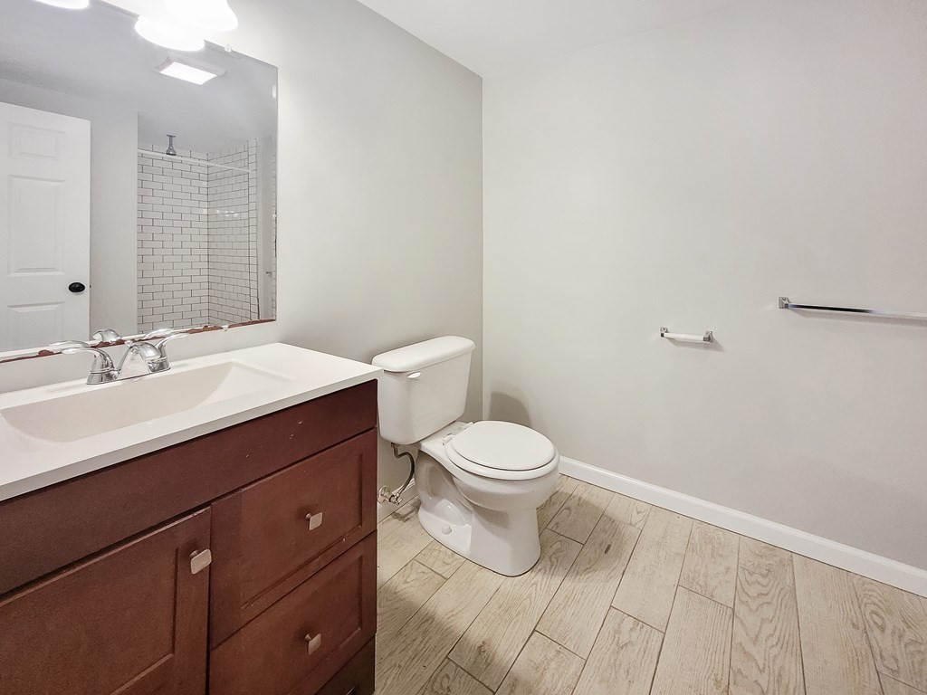 26 Arcadia Street, Unit 3R Boston, MA 02122 - Photo 6 of 8 a bathroom with a sink a toilet and mirror