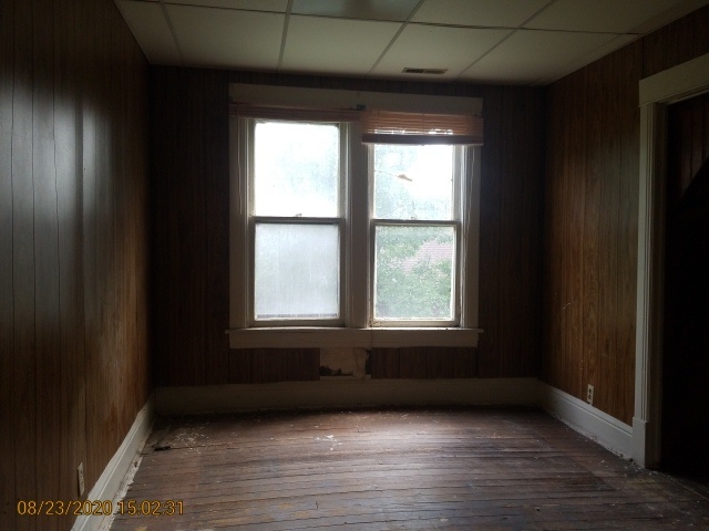 909 North 3rd Street Springfield, IL 62702 - Photo 16 of 22 a view of an empty room with wooden floor and a window