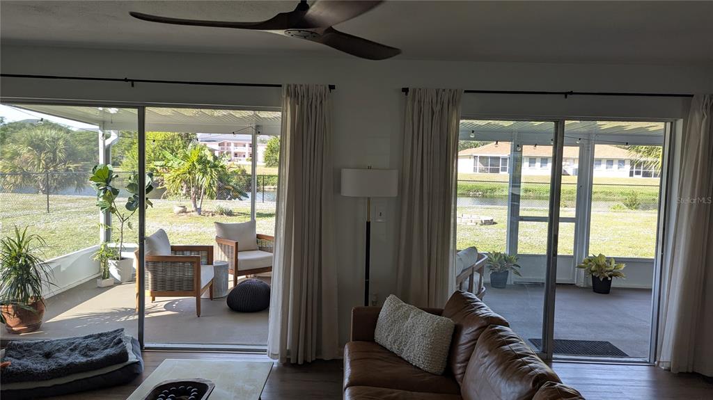 173 Rotonda Circle Rotonda West, FL 33947 - Photo 2 of 13 a living room with furniture and a floor to ceiling window