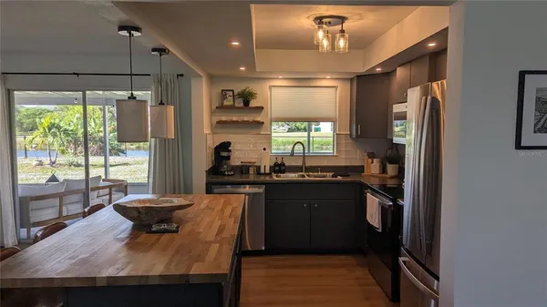 a kitchen with a table chairs and refrigerator