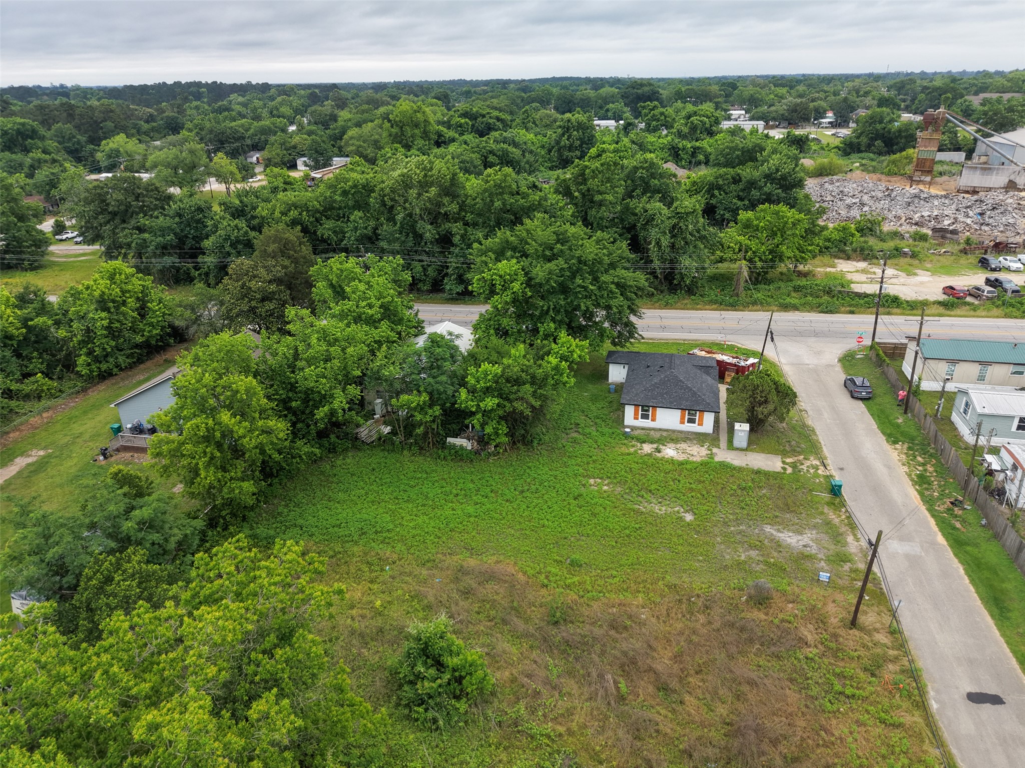 0 Mill Street Willis, TX 77378 - Photo 8 of 24 a view of a garden with a building in the background
