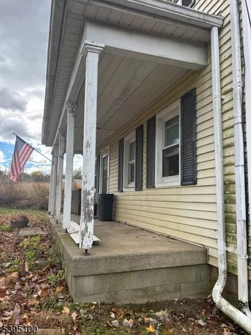 a front view of a house with a fountain